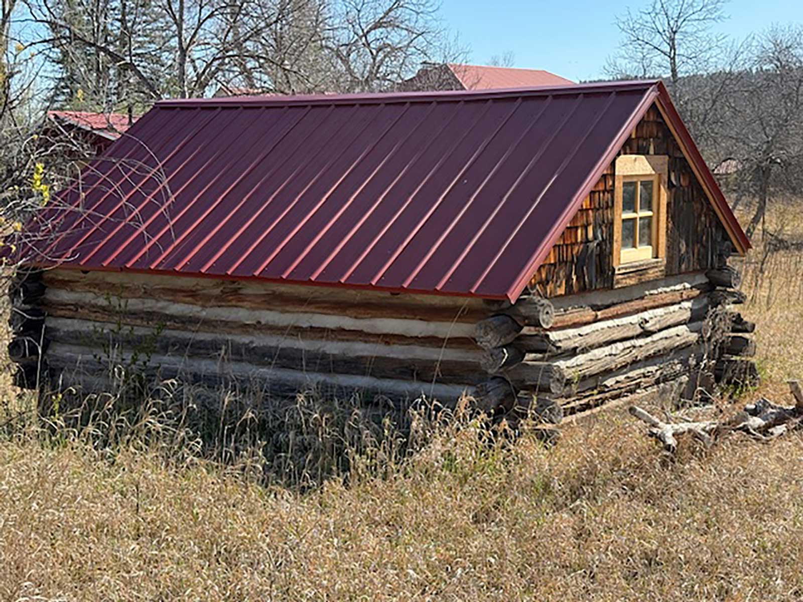 A row of weathered historic wood-frame buildings in the American West